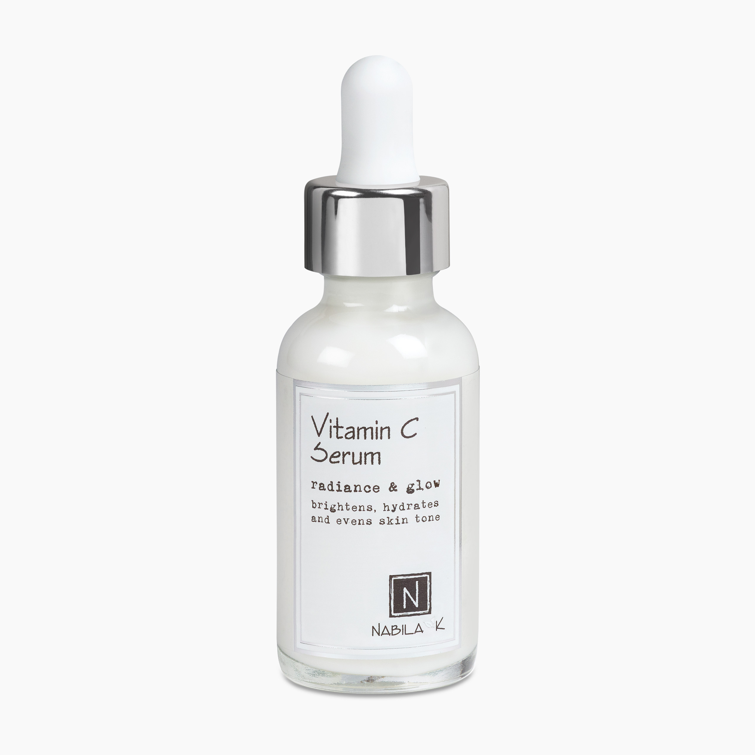 A bottle of “Nabila K” Vitamin C Serum, featuring a dropper and a sleek design, labeled with the text "radiance & glow" and claims to brighten, hydrate, and even skin tone.